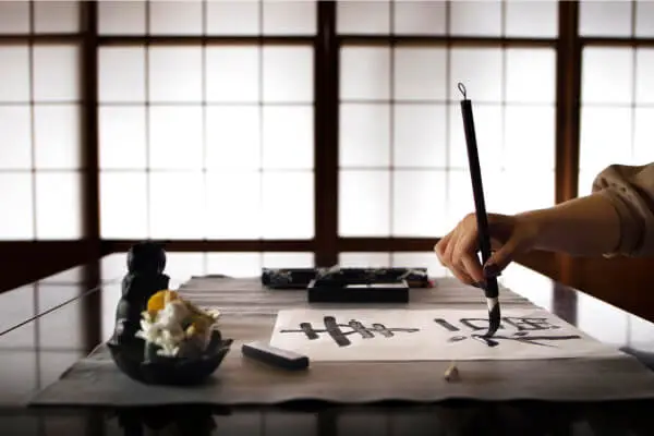 woman practicing japanese handwr